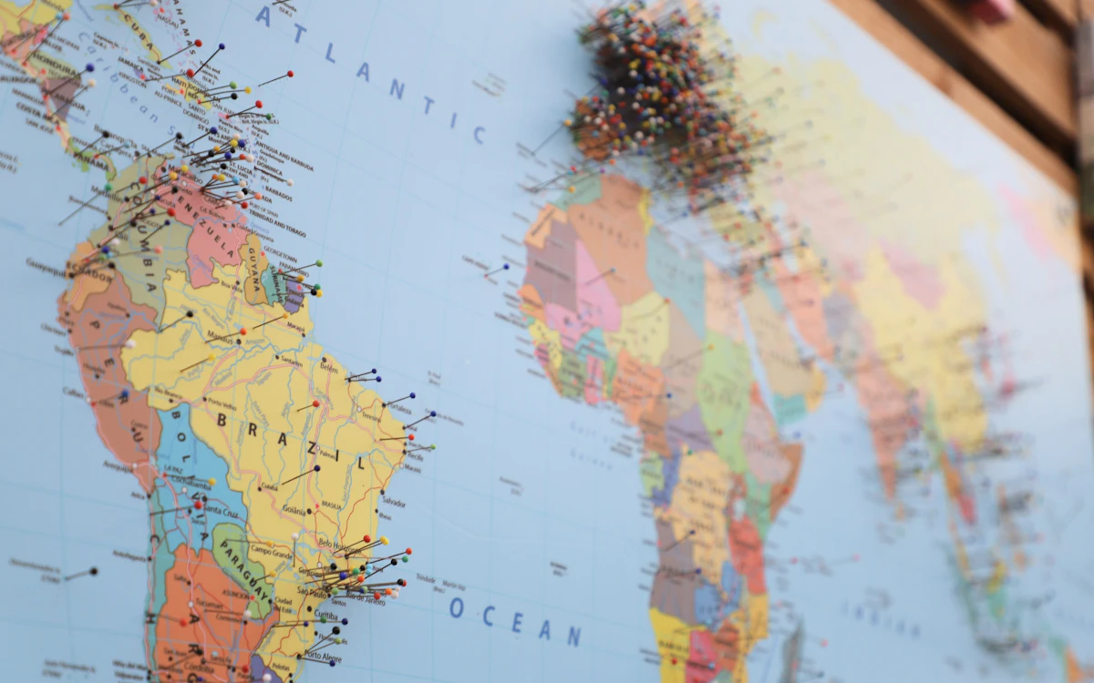 World map marked with pins to represent international market coverage.